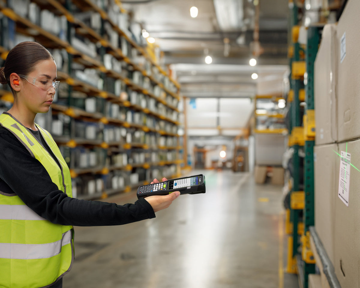 Zebra MC3450 rugged 5G keypad mobile computer, straight shooter, 29-key numeric keypad (MC345B-3S1J52SS-A6) – in use in a warehouse